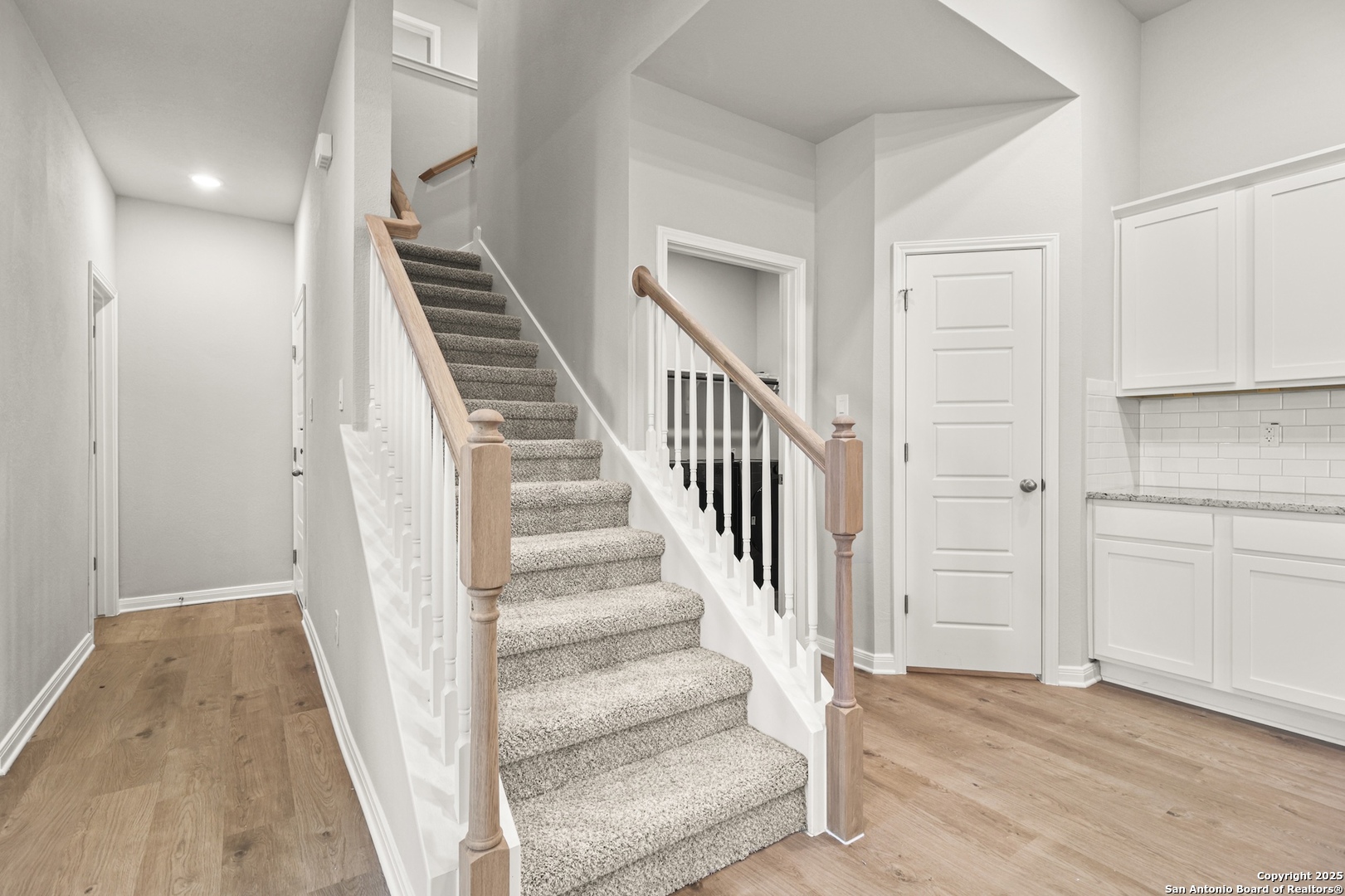 418 Cross Barn Boulevard, Unit B Buda, TX 78610 - Photo 22 of 35 a view of a hallway with wooden floor and entryway