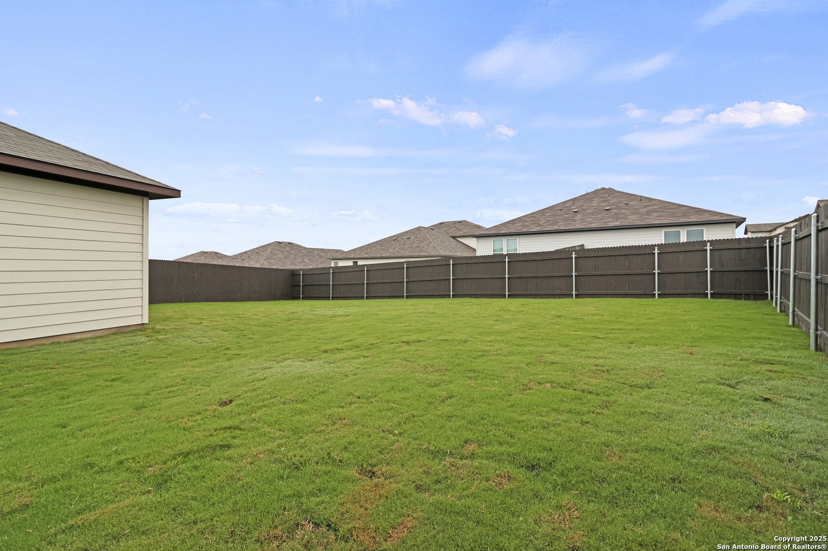 418 Cross Barn Boulevard, Unit B Buda, TX 78610 - Photo 32 of 35 a view of a yard with a house in the background