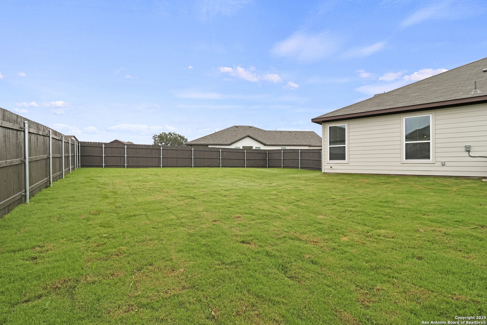 418 Cross Barn Boulevard, Unit B Buda, TX 78610 - Photo 35 of 35 a view of a house with a yard and sitting area