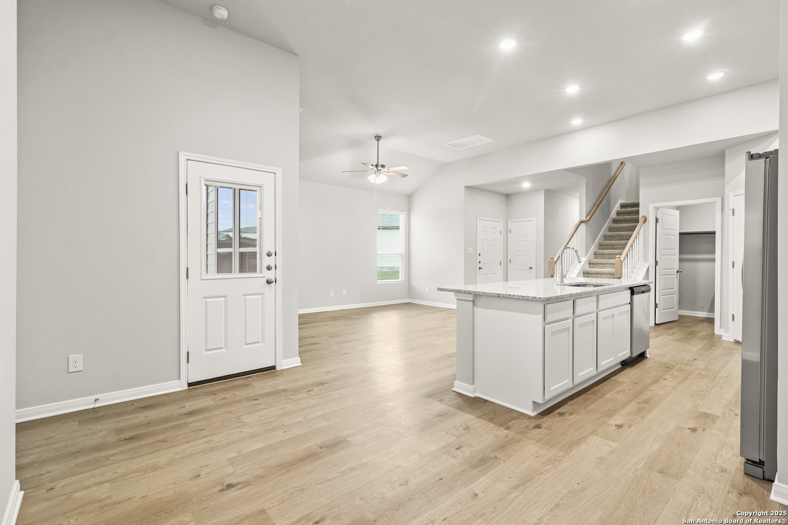 418 Cross Barn Boulevard, Unit B Buda, TX 78610 - Photo 4 of 35 a large white kitchen with a lot of counter space and wooden floor