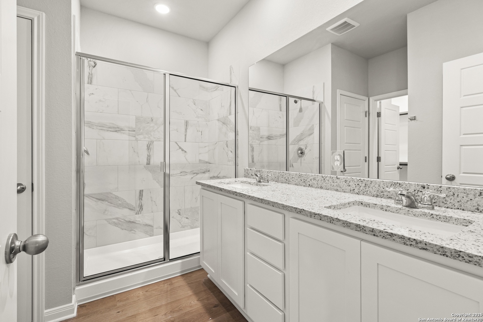 418 Cross Barn Boulevard, Unit B Buda, TX 78610 - Photo 5 of 35 a bathroom with a granite countertop sink a mirror and a shower