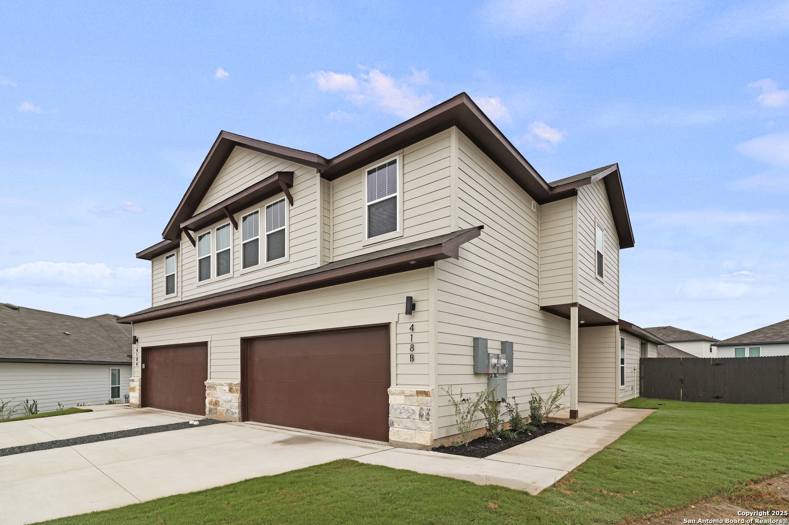418 Cross Barn Boulevard, Unit B Buda, TX 78610 - Photo 6 of 35 a front view of a house with a yard and garage