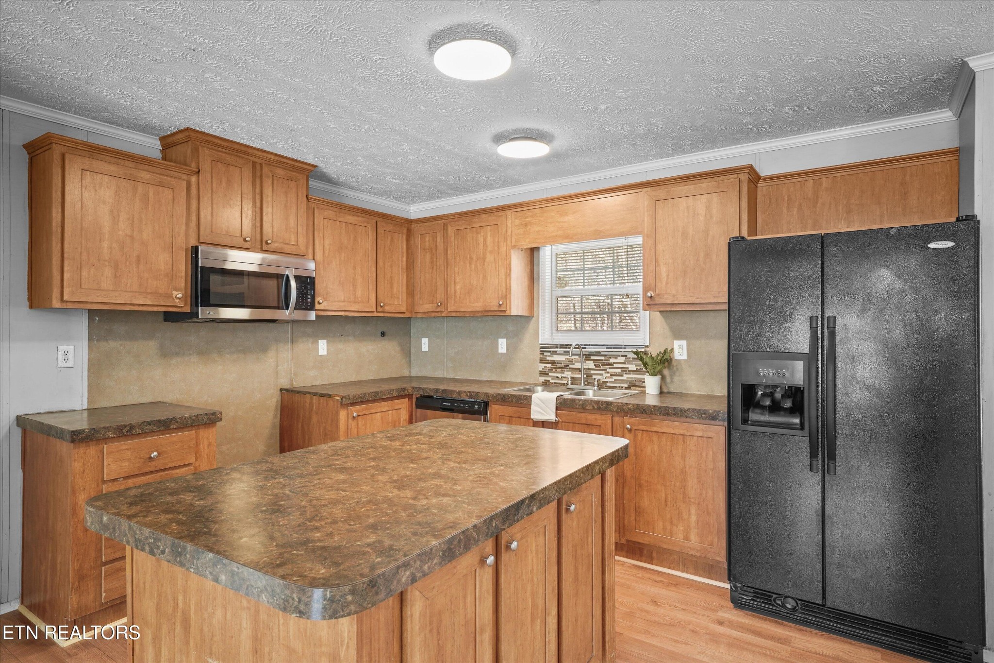 603 Bays Mountain Road Knoxville, TN 37920 - Photo 6 of 30 a kitchen with stainless steel appliances granite countertop a refrigerator a sink a stove a washer dryer and cabinets