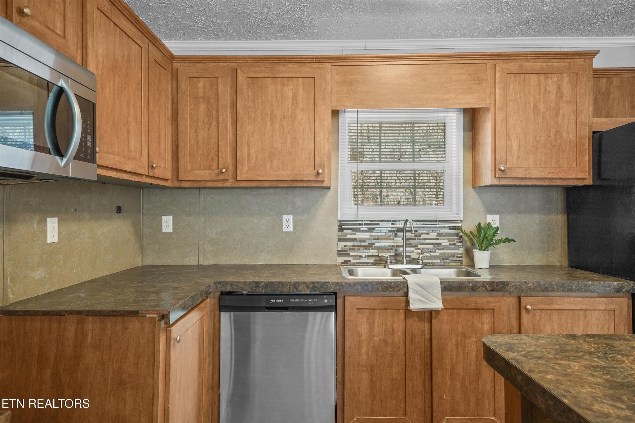 603 Bays Mountain Road Knoxville, TN 37920 - Photo 7 of 30 a kitchen with stainless steel appliances granite countertop a sink stove and microwave