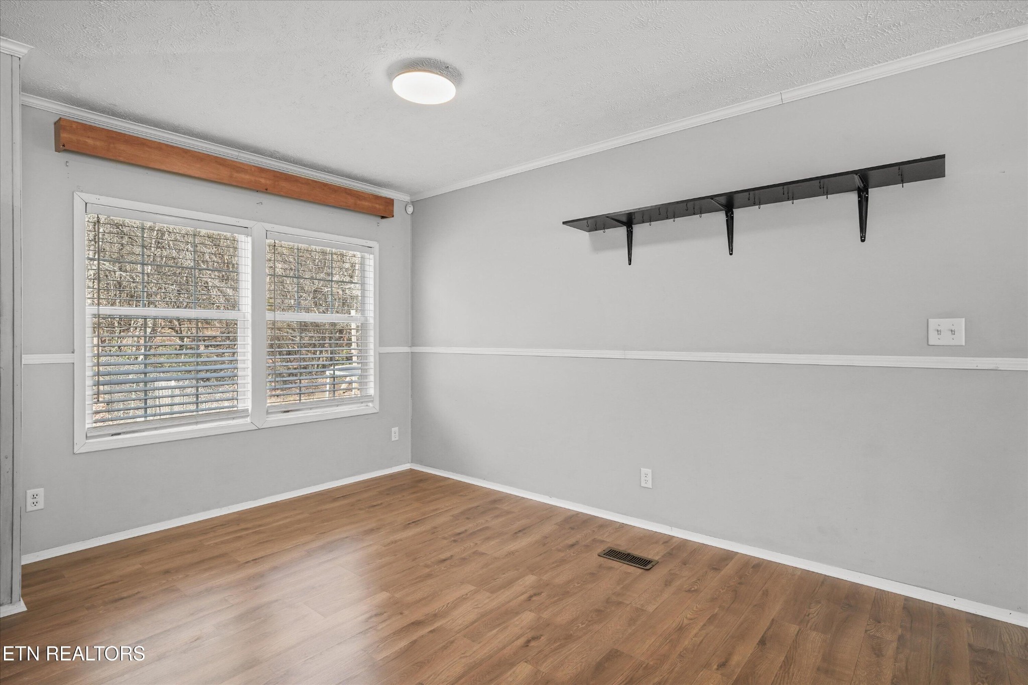 603 Bays Mountain Road Knoxville, TN 37920 - Photo 8 of 30 a view of an empty room with wooden floor and a window
