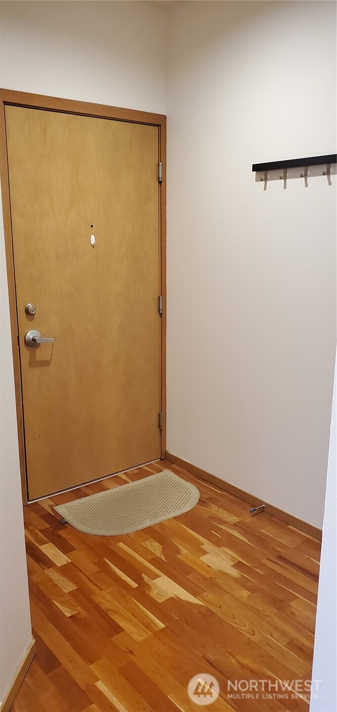 668 South Lane Street, Unit 314 Seattle, WA 98104 - Photo 14 of 23 an empty room with wooden floor