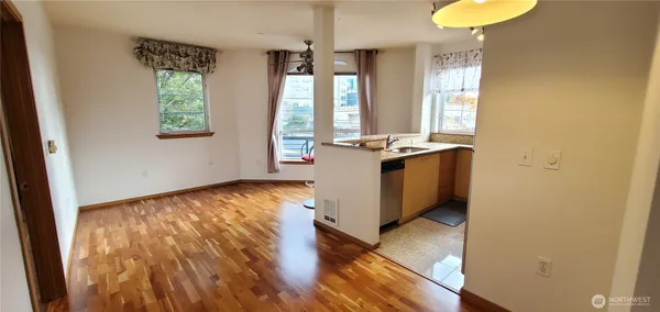 a view of a room with wooden floor and windows