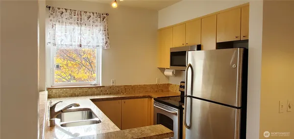 a kitchen with refrigerator and window