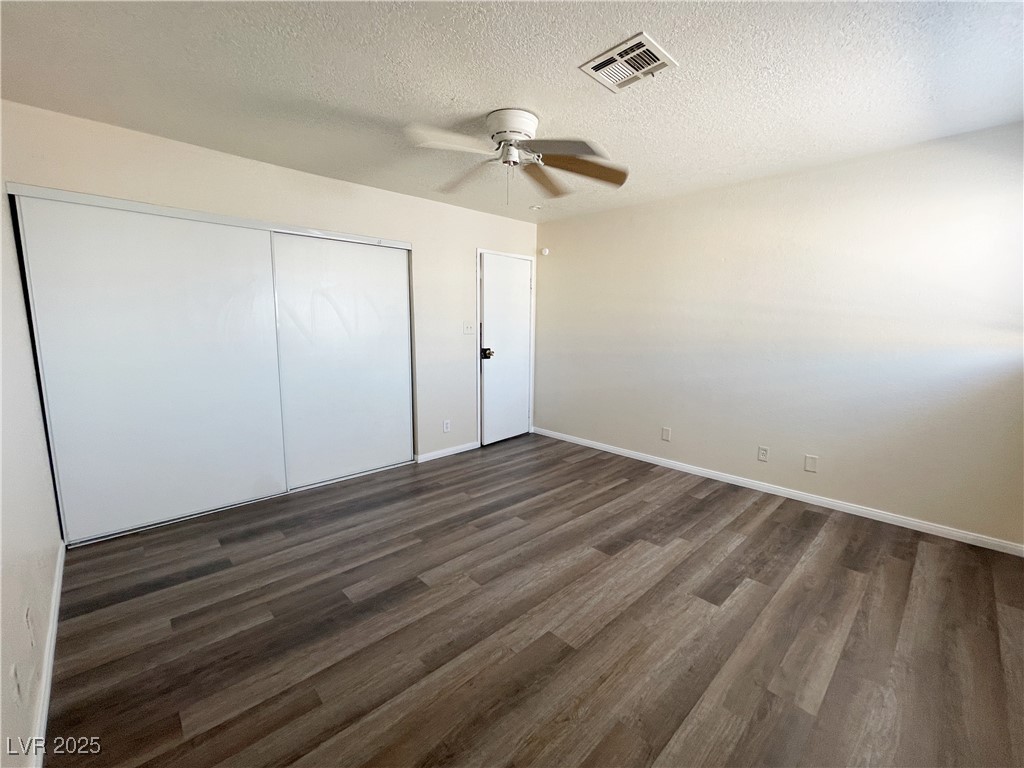 6917 Mendon Lane, Unit 4 Las Vegas, NV 89156 - Photo 11 of 12 Unfurnished bedroom featuring a textured ceiling,