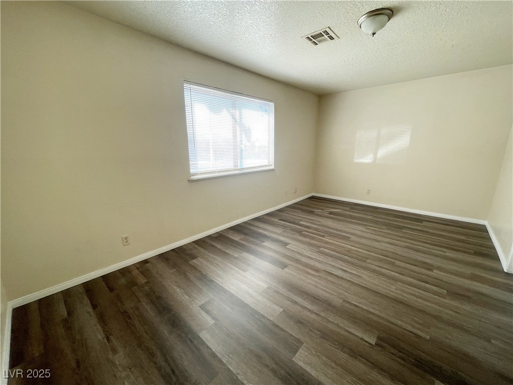 6917 Mendon Lane, Unit 4 Las Vegas, NV 89156 - Photo 3 of 12 Spare room featuring a textured ceiling and dark w