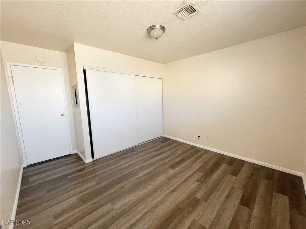 6917 Mendon Lane, Unit 4 Las Vegas, NV 89156 - Photo 8 of 12 Unfurnished bedroom with a textured ceiling, a clo