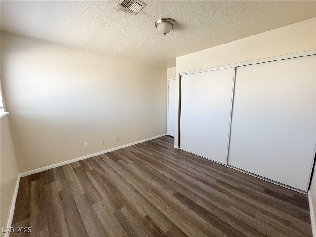 6917 Mendon Lane, Unit 4 Las Vegas, NV 89156 - Photo 9 of 12 Unfurnished bedroom featuring a textured ceiling,