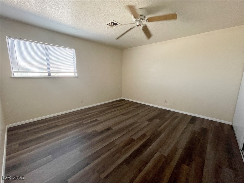 6917 Mendon Lane, Unit 4 Las Vegas, NV 89156 - Photo 10 of 12 Unfurnished room featuring a textured ceiling, dar