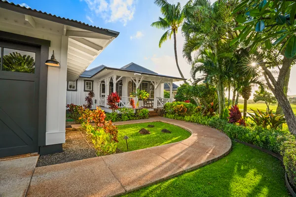 a front view of a house with swimming pool having outdoor seating
