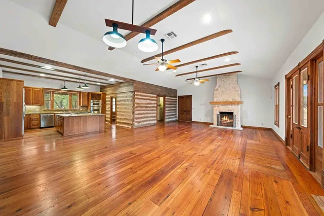 a view of a room with wooden floor and chandelier