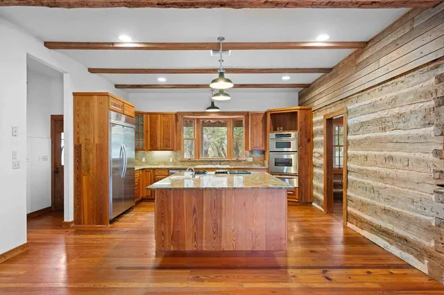 a kitchen with stainless steel appliances granite countertop a stove and a sink