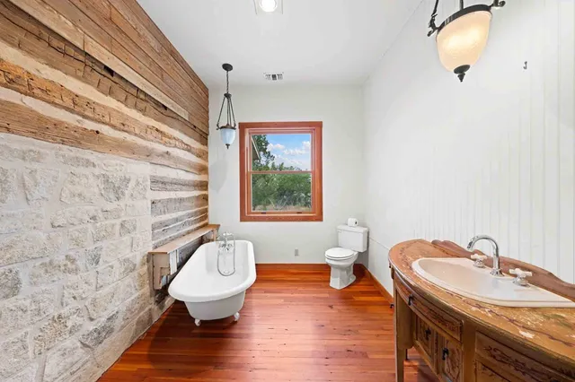 a bathroom with a sink toilet and a mirror