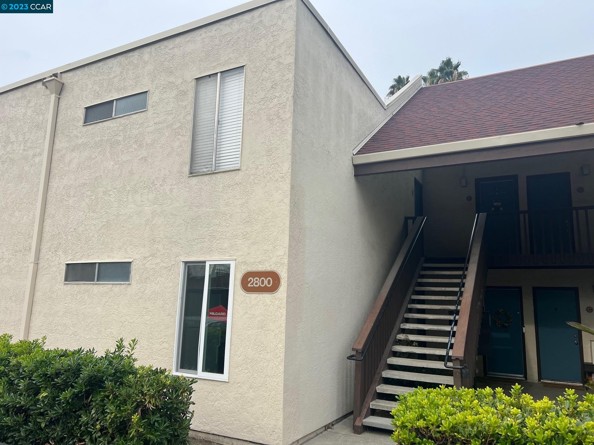 a front view of a house with stairs