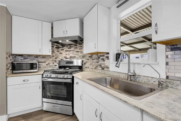 a kitchen with a stove and a sink