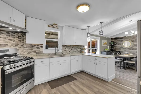 a kitchen with stainless steel appliances granite countertop a stove and a sink