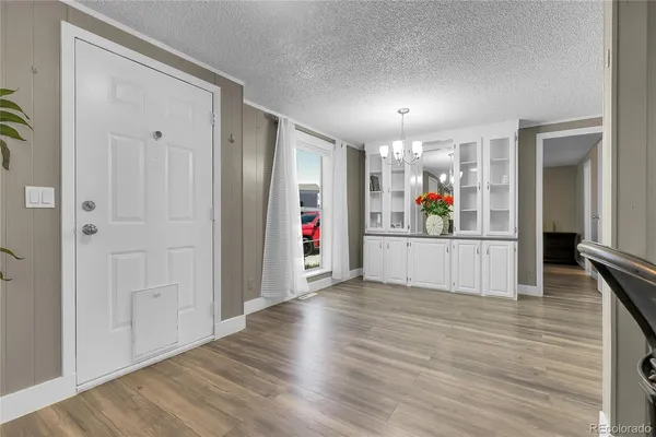a view of a hallway with wooden floor and closet
