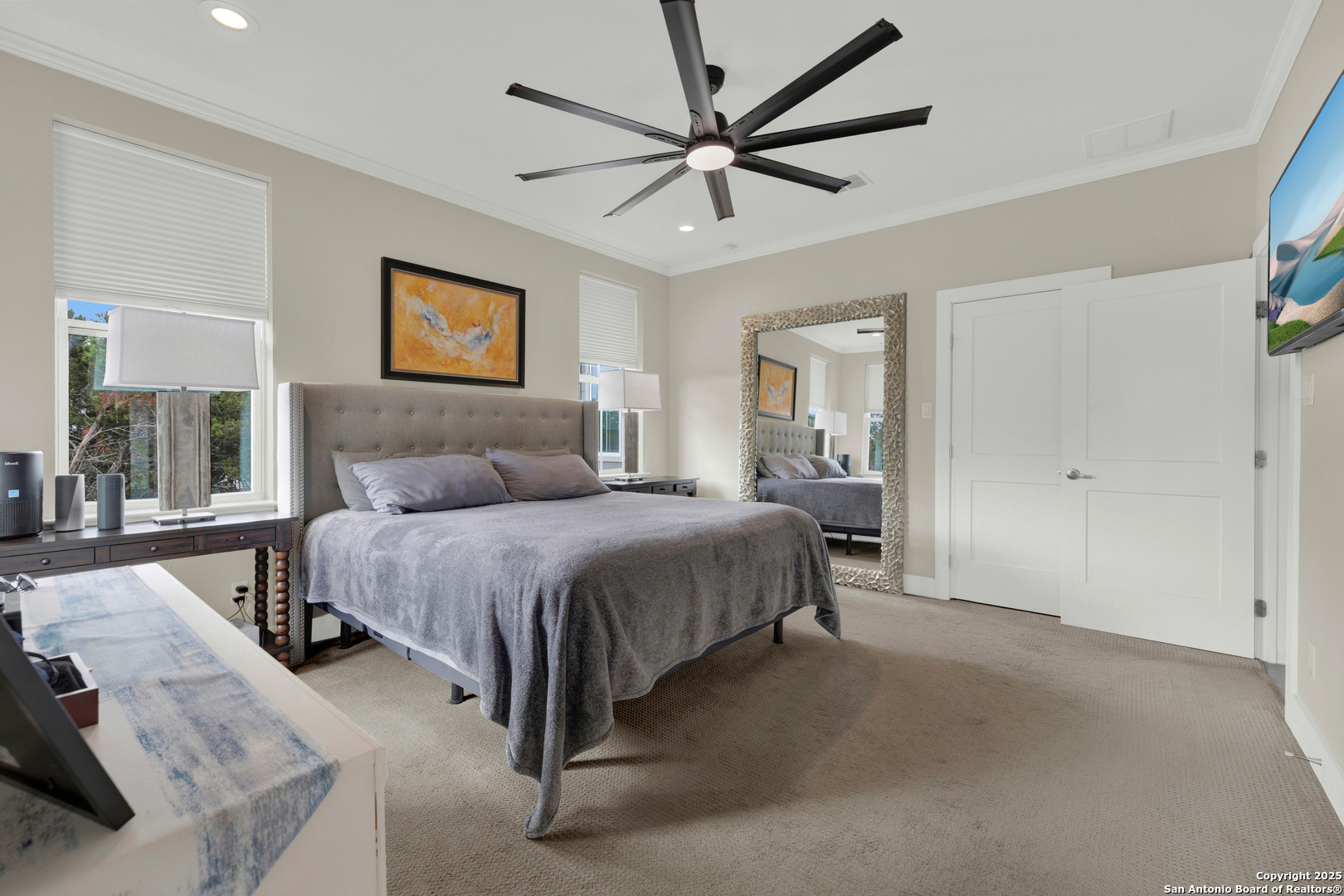 232 Freedom Street Fischer, TX 78623 - Photo 16 of 38 a spacious bedroom with a bed and a large mirror