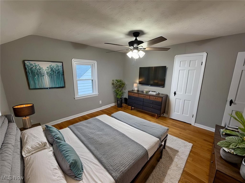 6807 Gerald Avenue Parma, OH 44129 - Photo 10 of 25 Bedroom with light wood-style flooring, a textured ceiling, baseboards, and a ceiling fan virtually staged