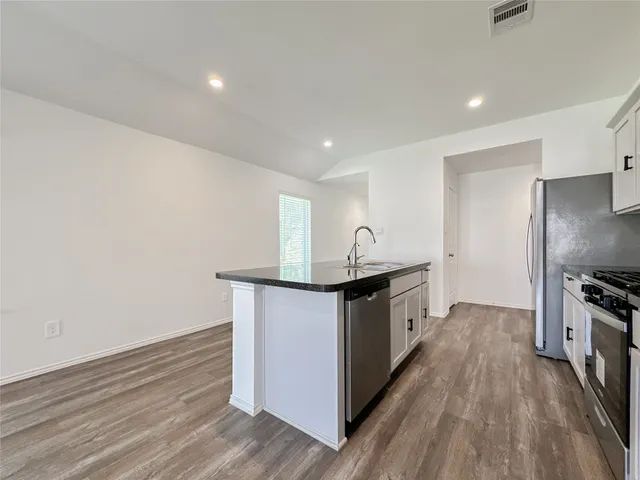 a kitchen with stainless steel appliances a sink and a stove