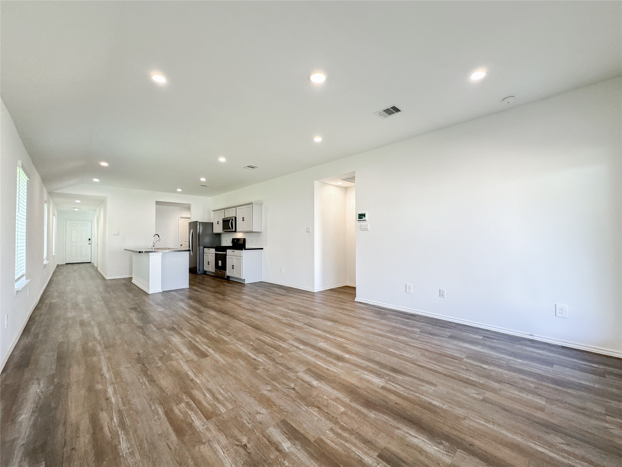 5715 Vintage Oakmont Drive Spring, TX 77373 - Photo 28 of 39 a view of kitchen and empty room with wooden floor