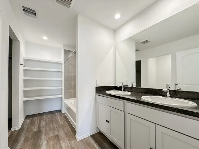 a bathroom with a double vanity sink and a mirror