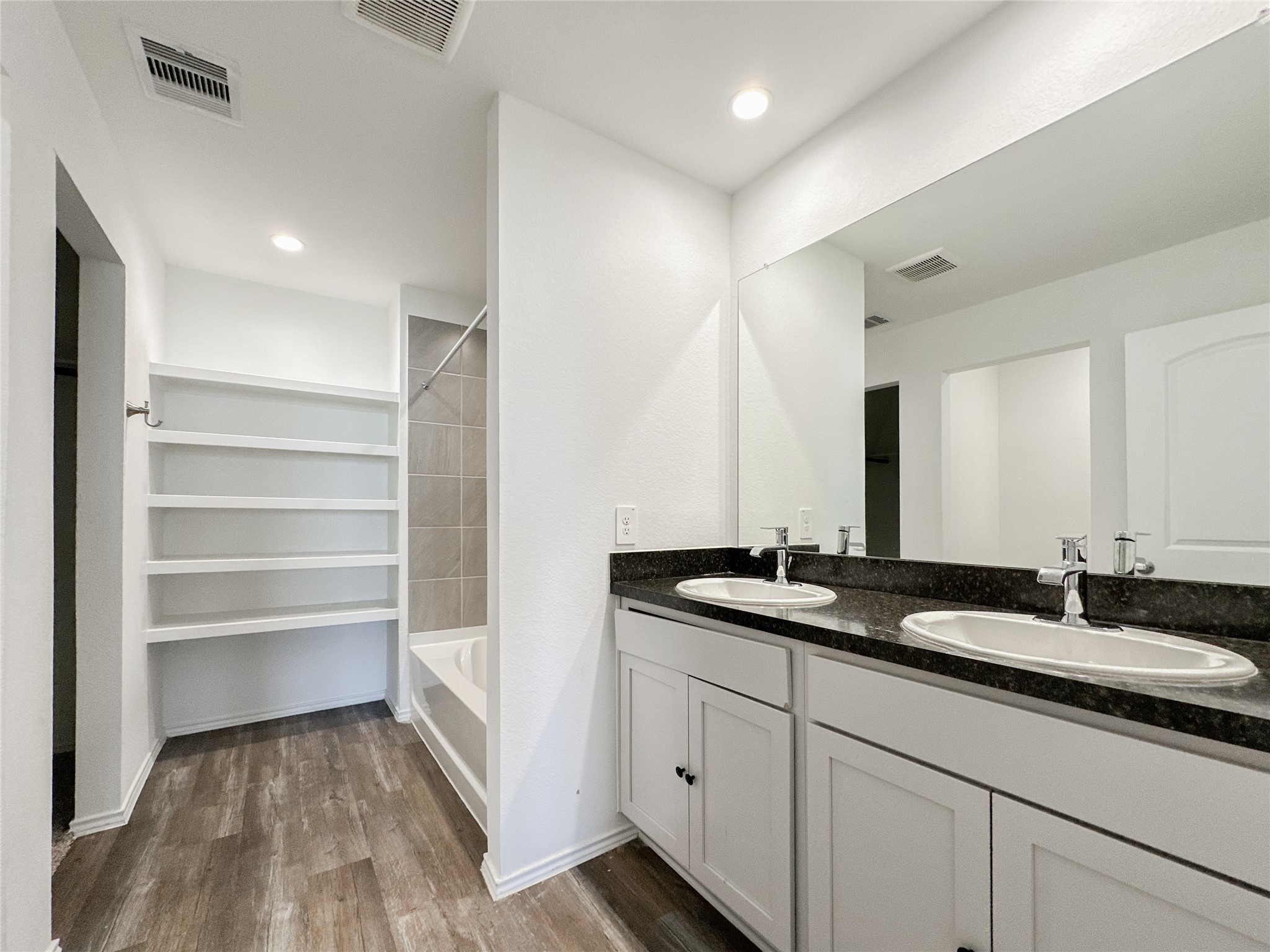 5715 Vintage Oakmont Drive Spring, TX 77373 - Photo 32 of 39 a bathroom with a double vanity sink and a mirror