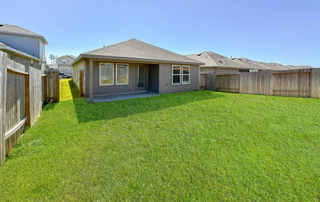 a view of a yard in front of a house with large trees