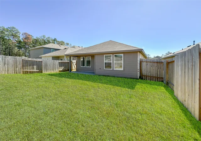 a view of a house with a yard and sitting area