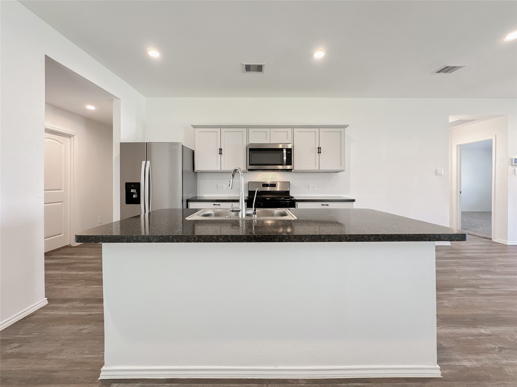 5715 Vintage Oakmont Drive Spring, TX 77373 - Photo 9 of 39 a large kitchen with stainless steel appliances granite countertop a sink a stove and a refrigerator