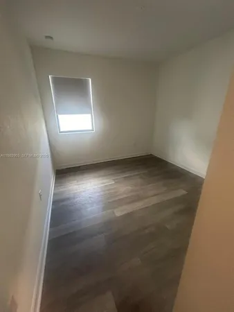 an empty room with windows and entrance