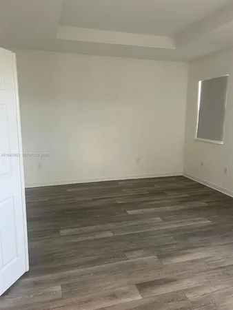 a view of an empty room and wooden floor