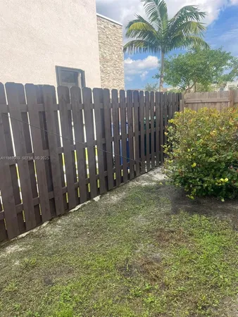 a view of a backyard with potted plants and water view