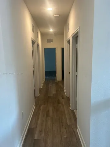 a view of hallway with stainless steel appliances