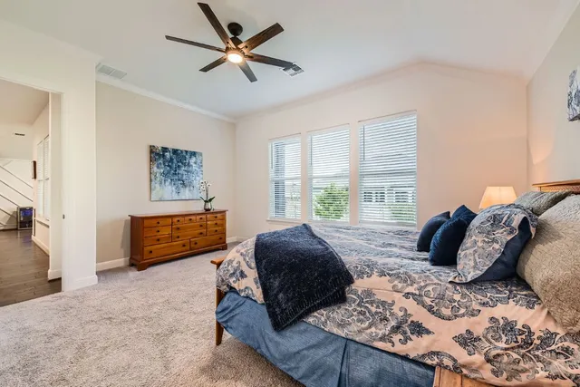 a spacious bedroom with a bed and window