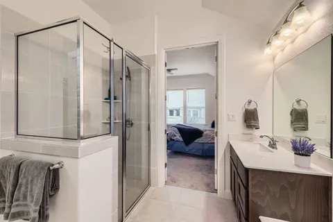 a spacious bathroom with a double vanity sink mirror and double