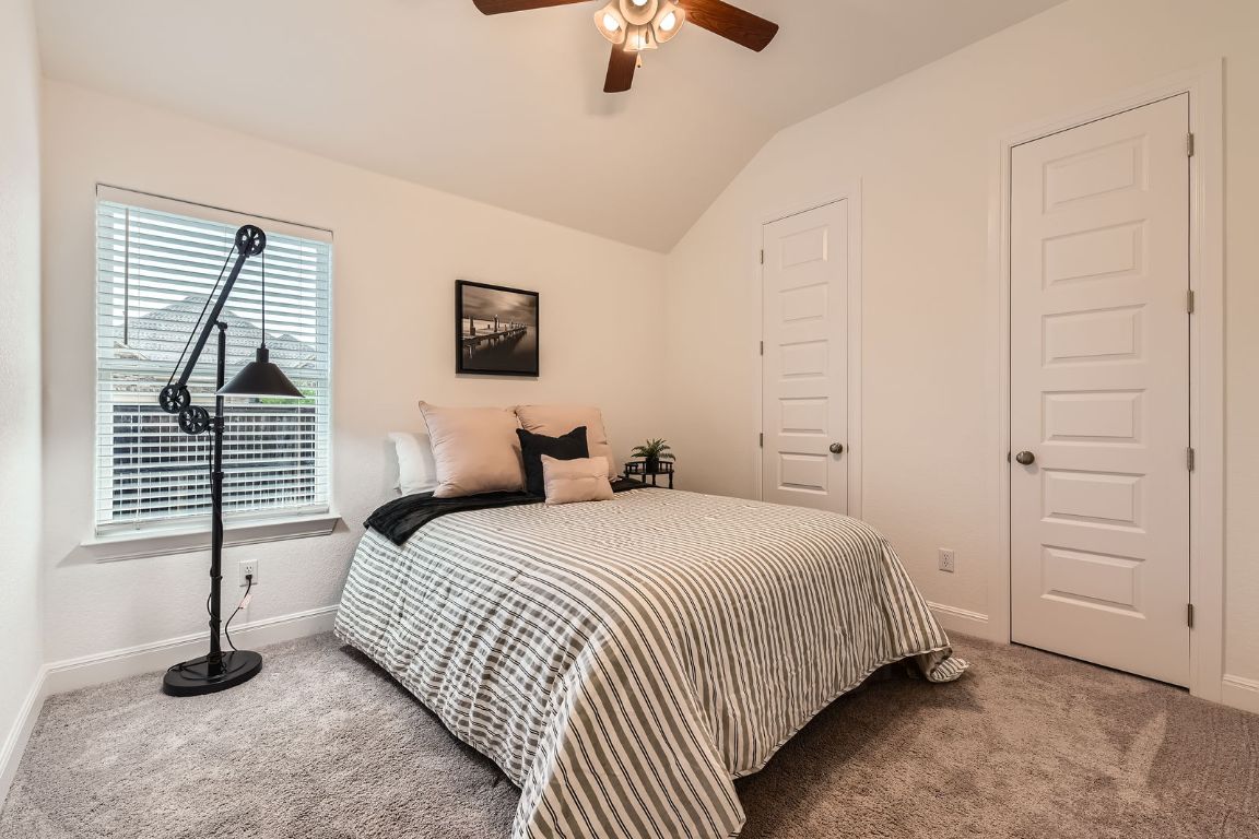 1332 Modoc Way Kyle, TX 78640 - Photo 18 of 28 Carpeted bedroom featuring lofted ceiling and ceiling fan