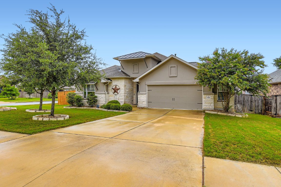 1332 Modoc Way Kyle, TX 78640 - Photo 2 of 28 View of front of home with stone siding, stucco siding, an attached garage, and concrete driveway
