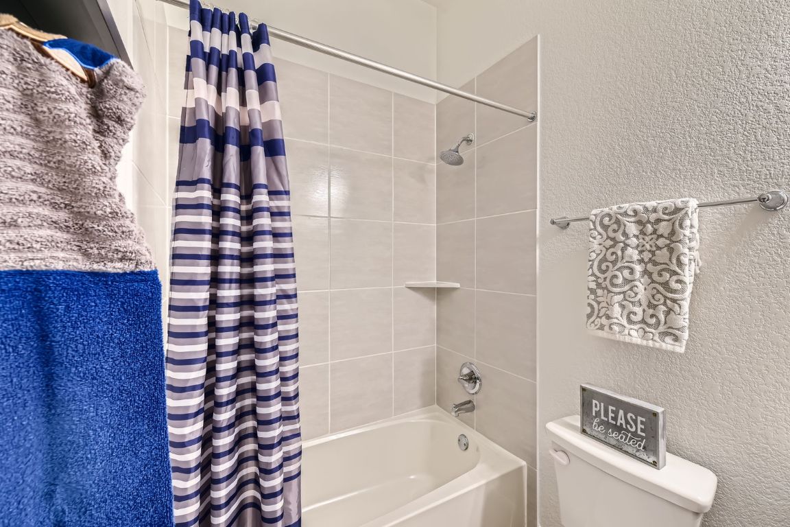 1332 Modoc Way Kyle, TX 78640 - Photo 21 of 28 Bathroom featuring shower / tub combo and a textured wall