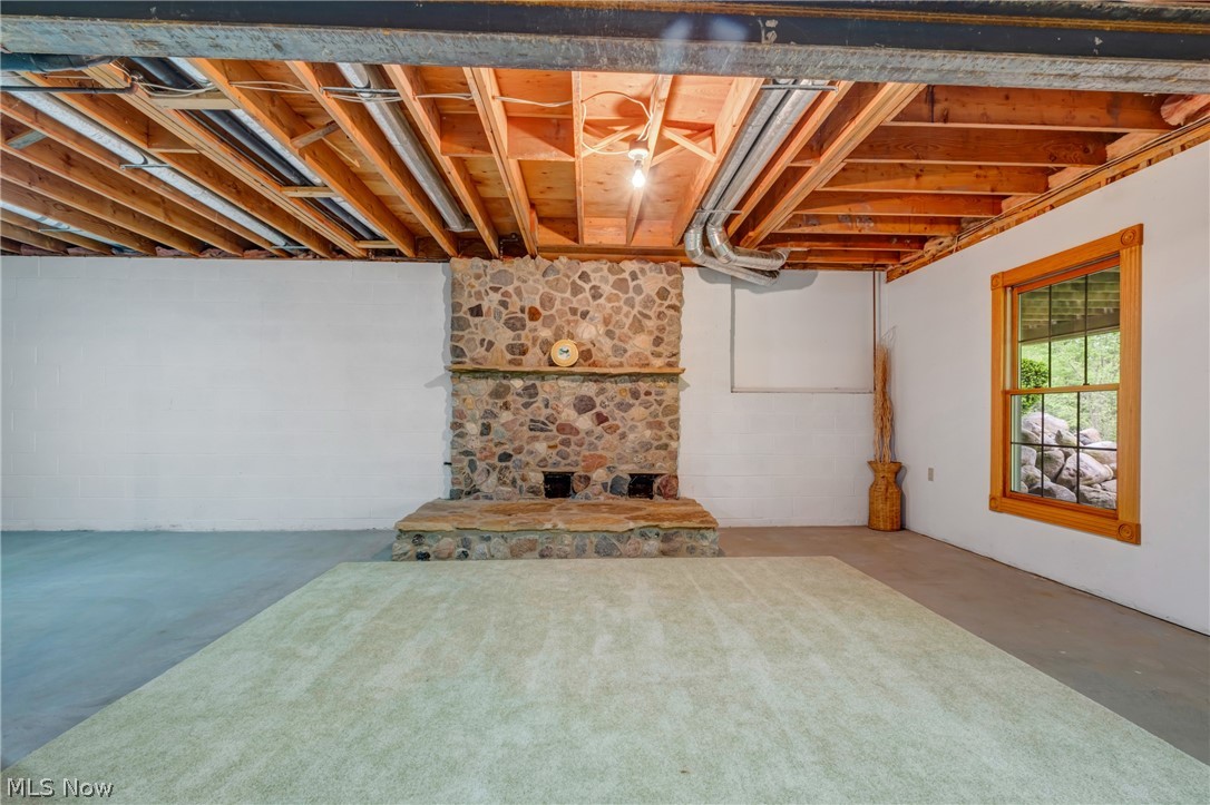 2645 Frost Road Mantua, OH 44255 - Photo 28 of 35 Gas fireplace is there finish this area for a great family or recreation room still have enough space for a theatre room and there are an additional 2 storage areas one with shelves.