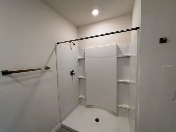 a bathroom with a shower and a toilet
