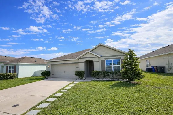 a front view of house with yard and green space