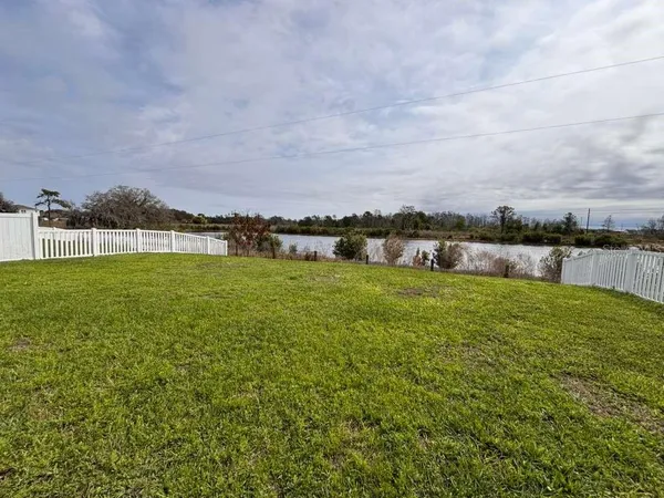 a view of a lake with houses in the back