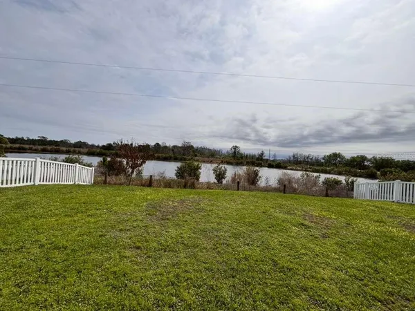 a view of a lake with houses in the back