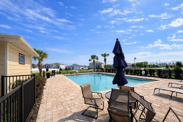 a view of a swimming pool with lounge chairs