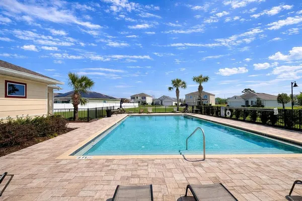 a view of swimming pool with outdoor seating